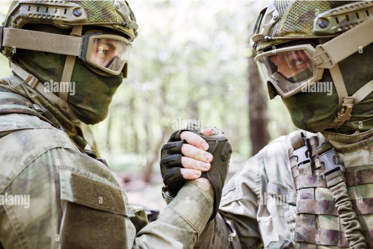 Two soldiers doing the warrior grip