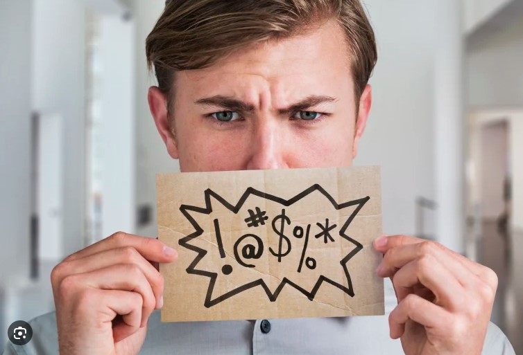 a man holding a card of curse symbols over his mouth